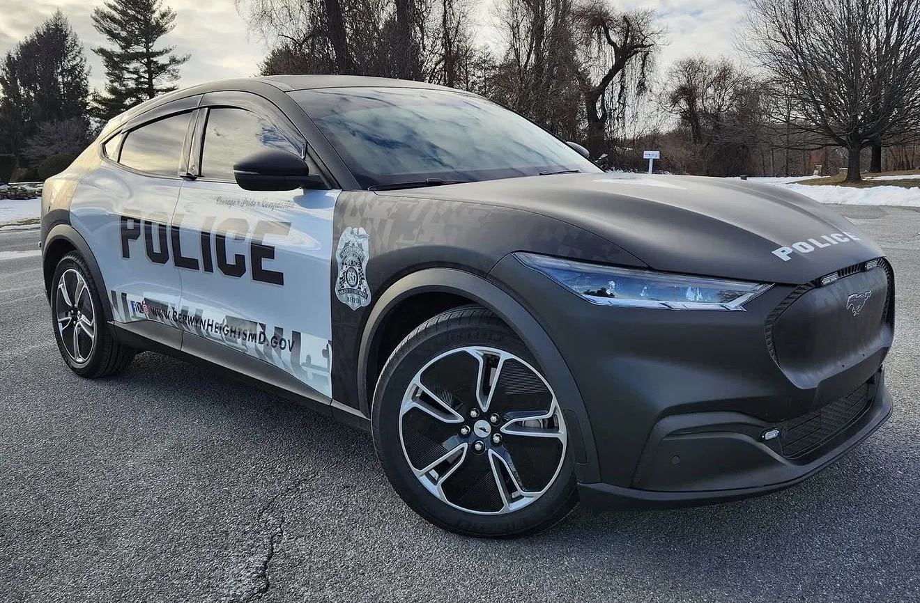 Police Mustang Mach-E with a black and white POLICE wrap, front three-quarter view