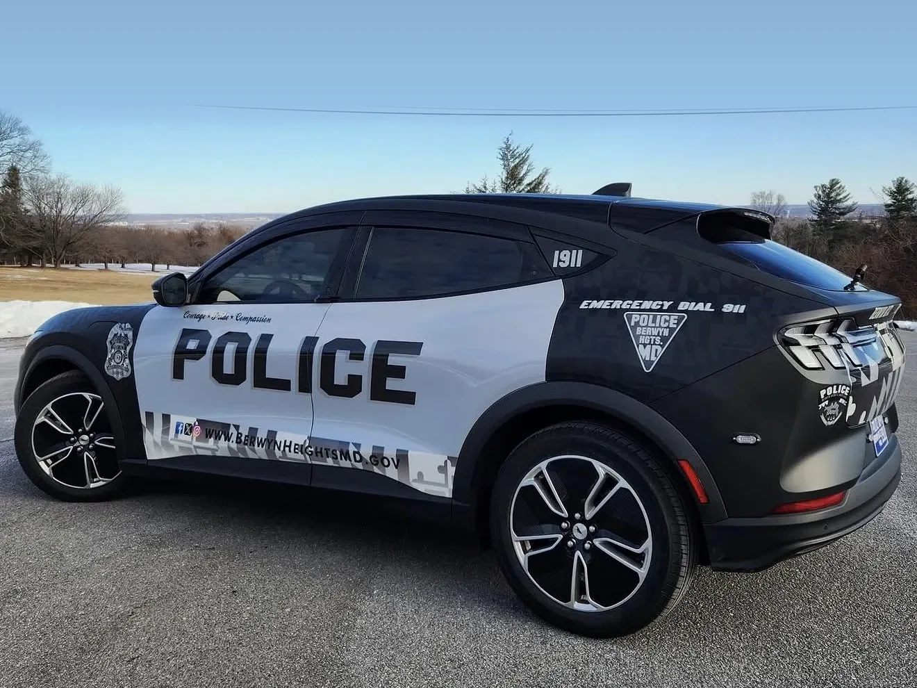 Berwyn Heights, MD police Mustang Mach-E with a black and white POLICE wrap and Maryland flag pattern, side view