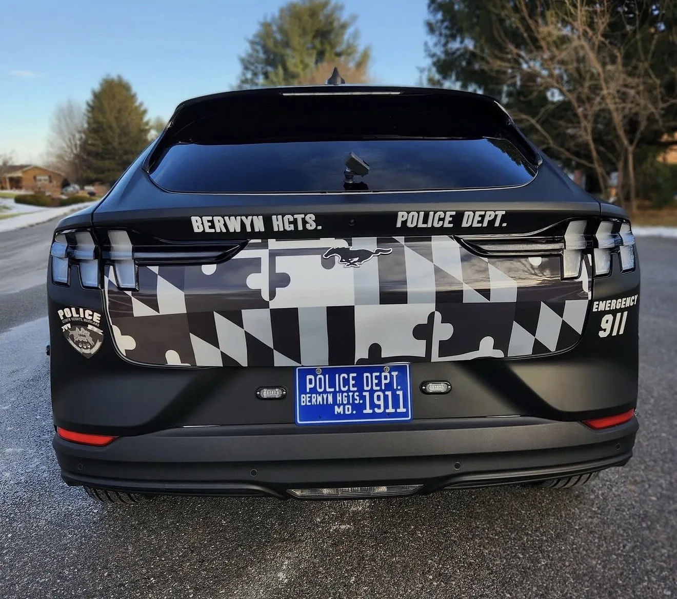 Rear of a police SUV with a Maryland flag wrap across the tailgate