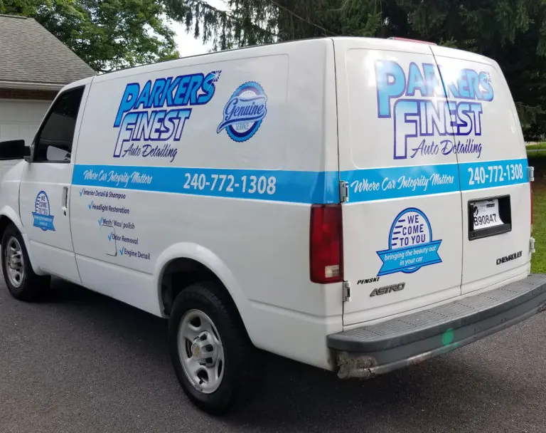 White service van with blue striped lettering and contact details