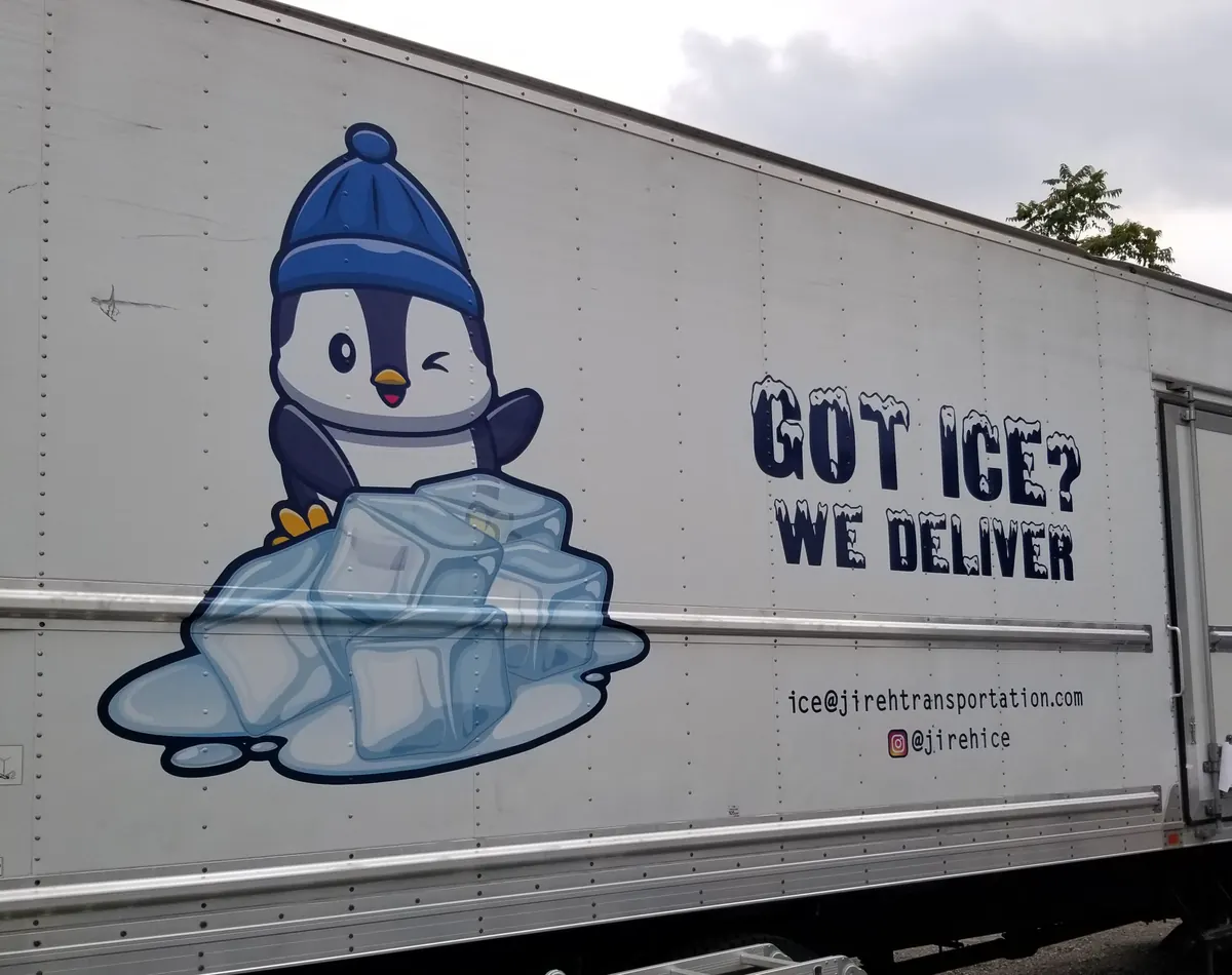 Delivery truck with a penguin and ice graphic