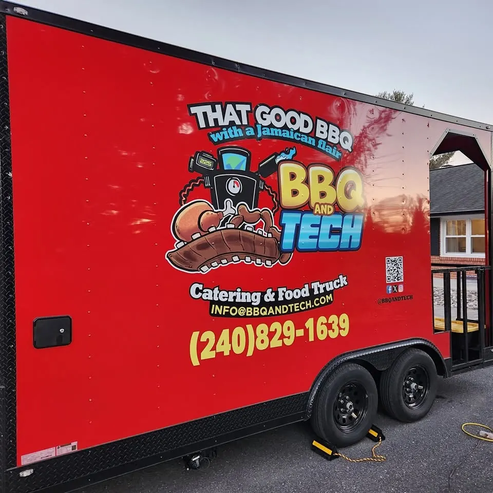 Red food truck trailer with colorful logo graphics