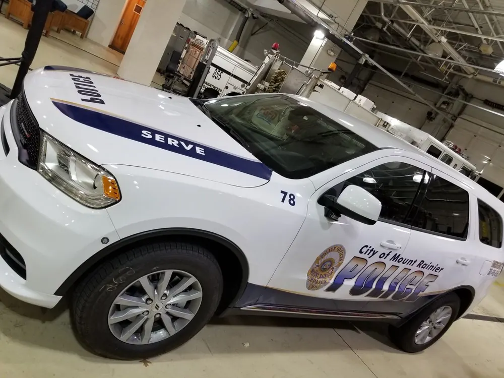 White police SUV with blue and gold graphics