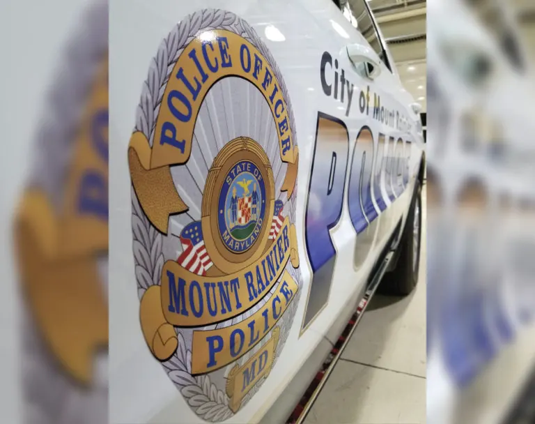 Close-up of a police badge graphic on a patrol vehicle door