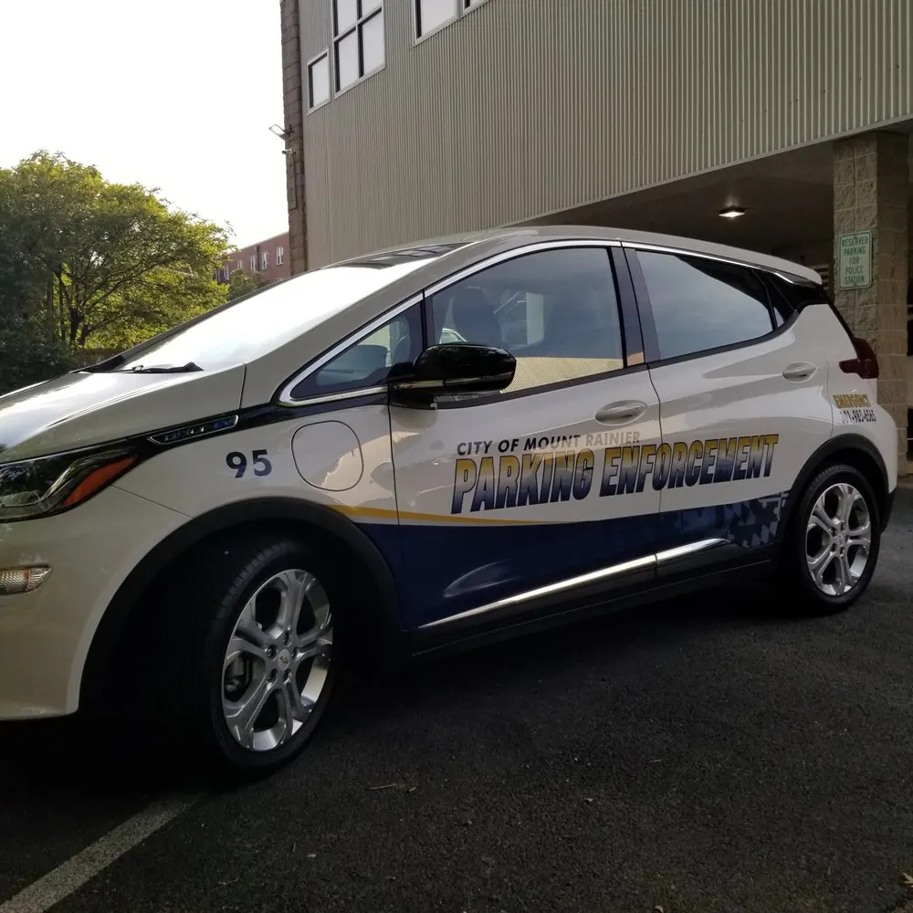 White electric car marked for parking enforcement