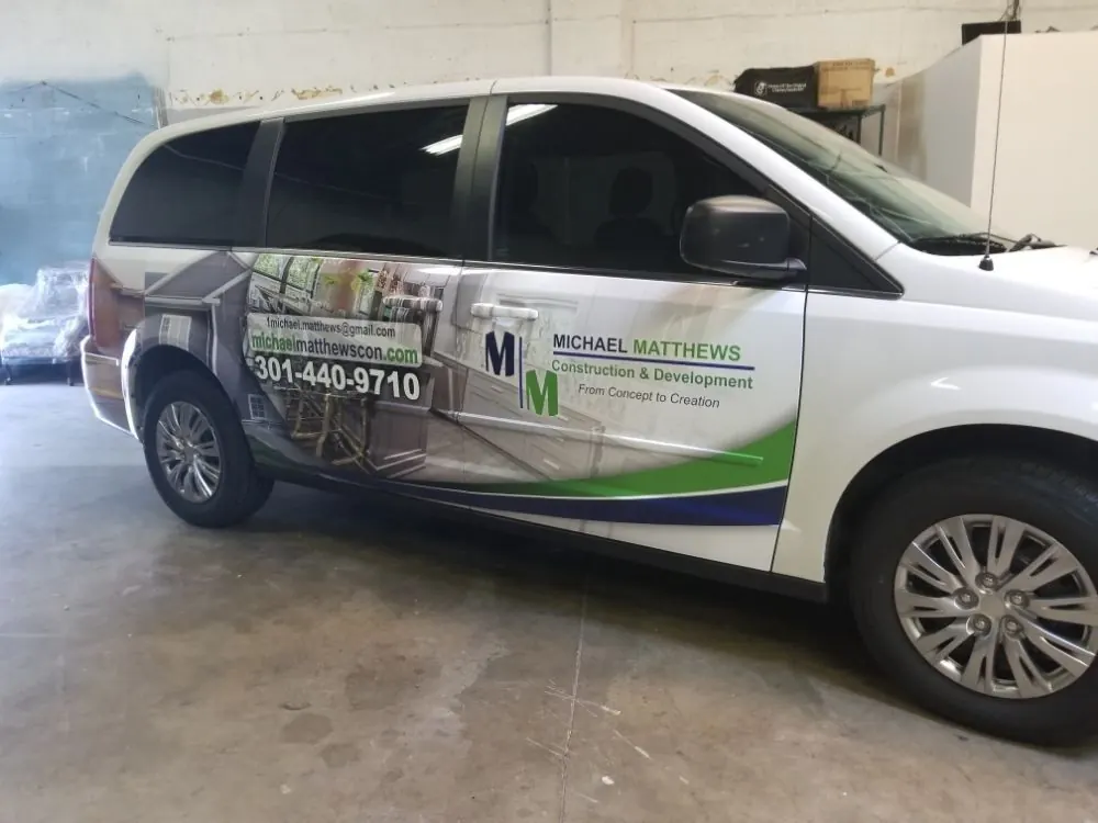 White minivan with a partial wrap for a construction company