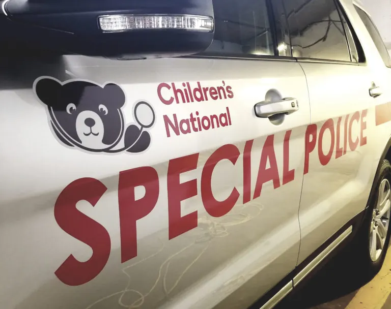 Silver special police SUV with red lettering